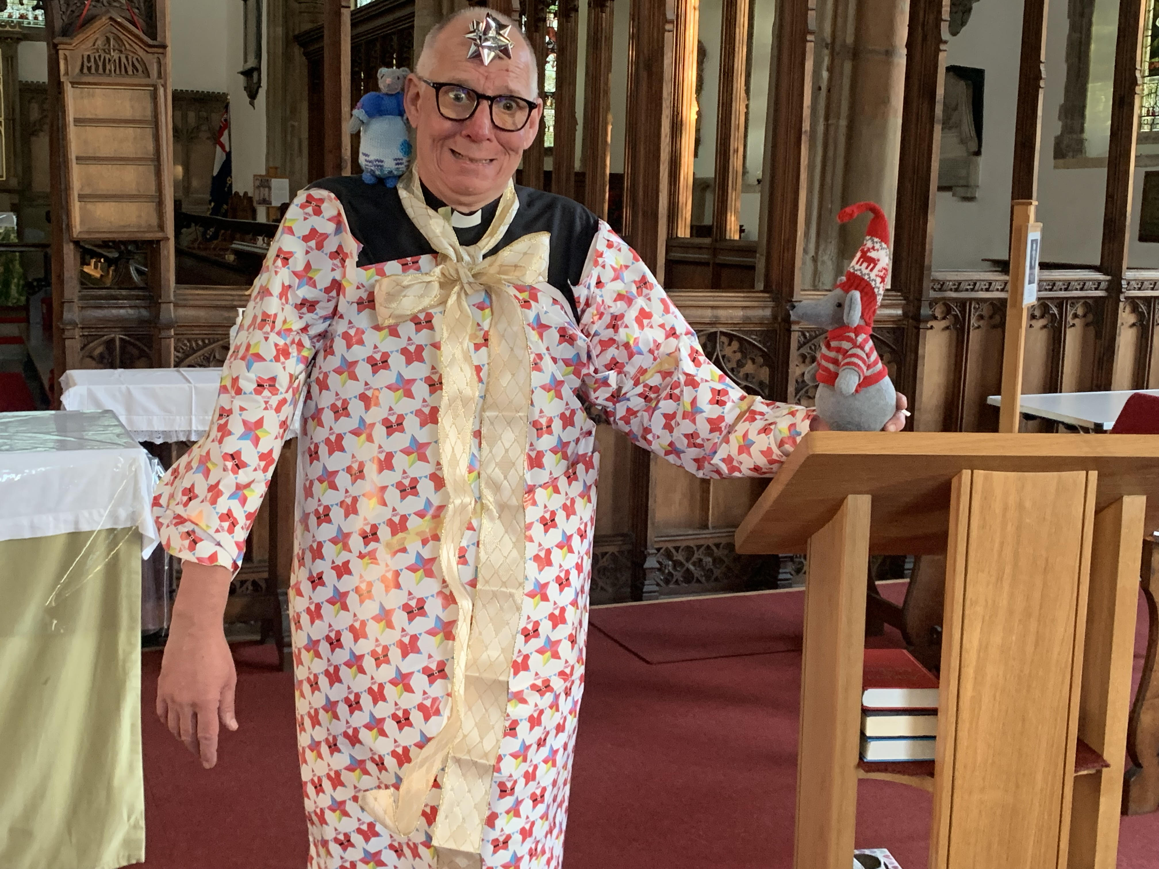 Chris wrapping the rector in Christmas paper